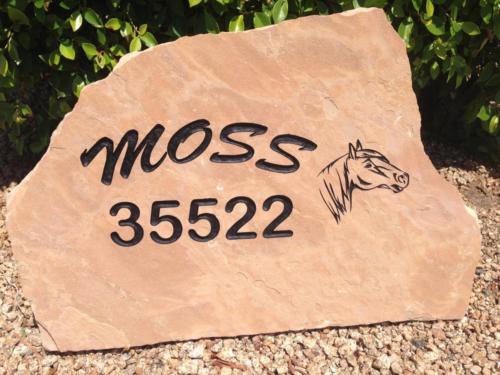 Address marker with family name on stone